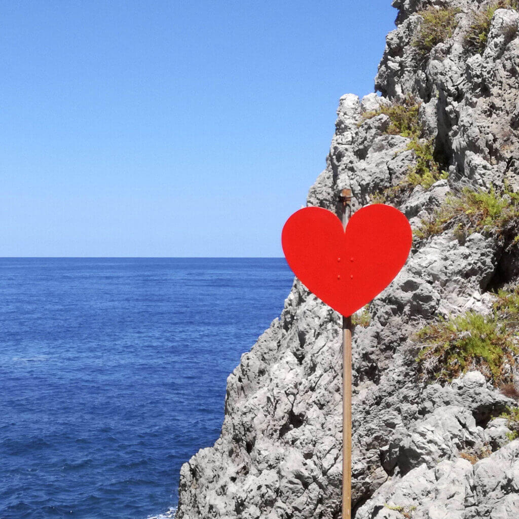 Tre Piscine Cala del Cuore, heart-shaped sign on the rocks-land-art